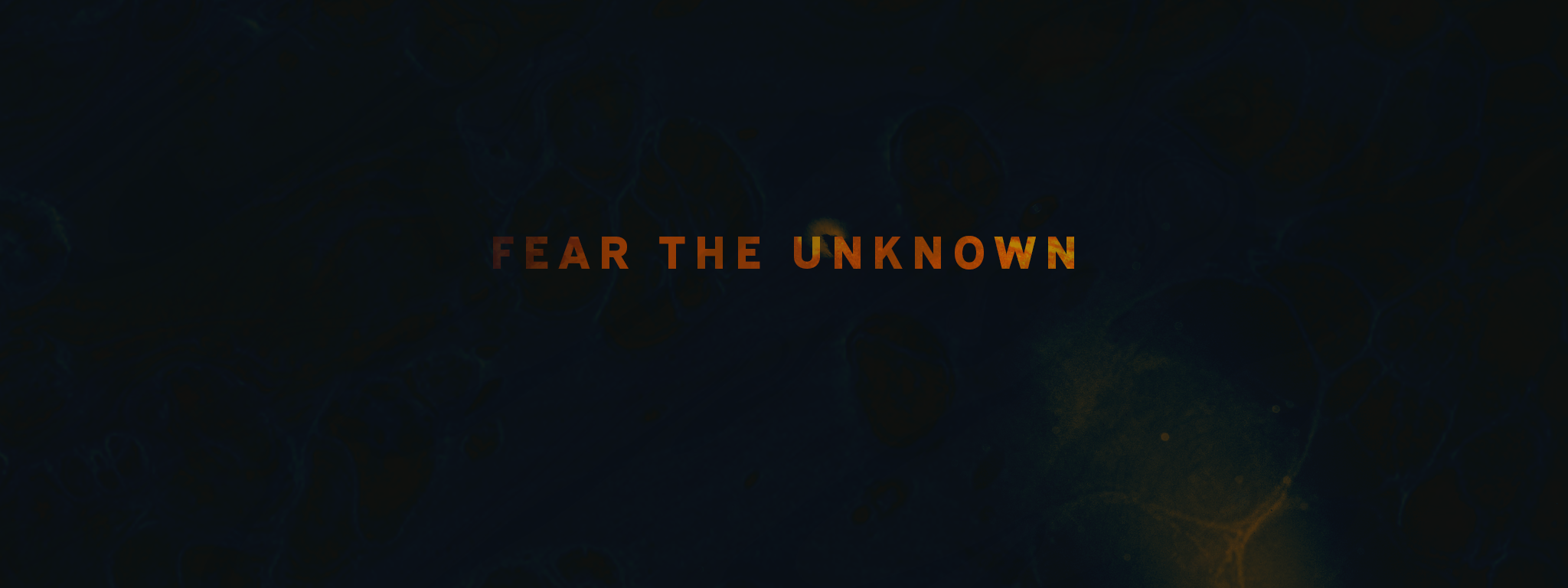 Text says "Fear the Unknown". It's a golden color, being slowly revealed as if lit by fire.